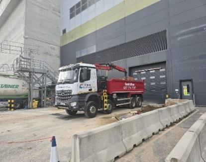 Grab truck servicing a commercial and industrial site
